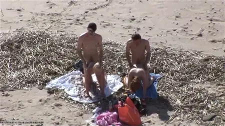 Eine Menge von Jungs am Strand lässt einen Kreis von zwei Prostituierten in den Kreis